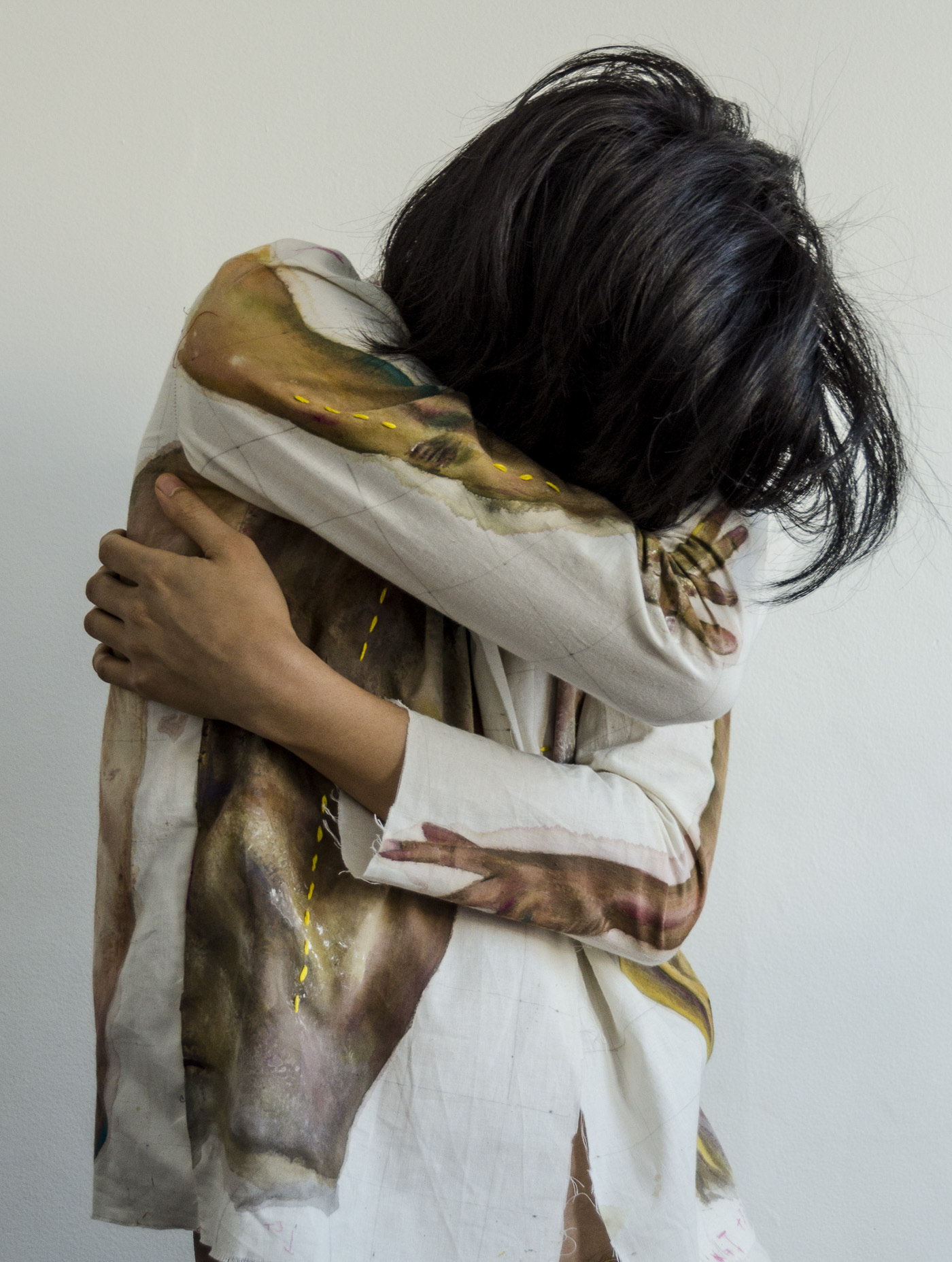 a person poses with a jacket painted with their own image