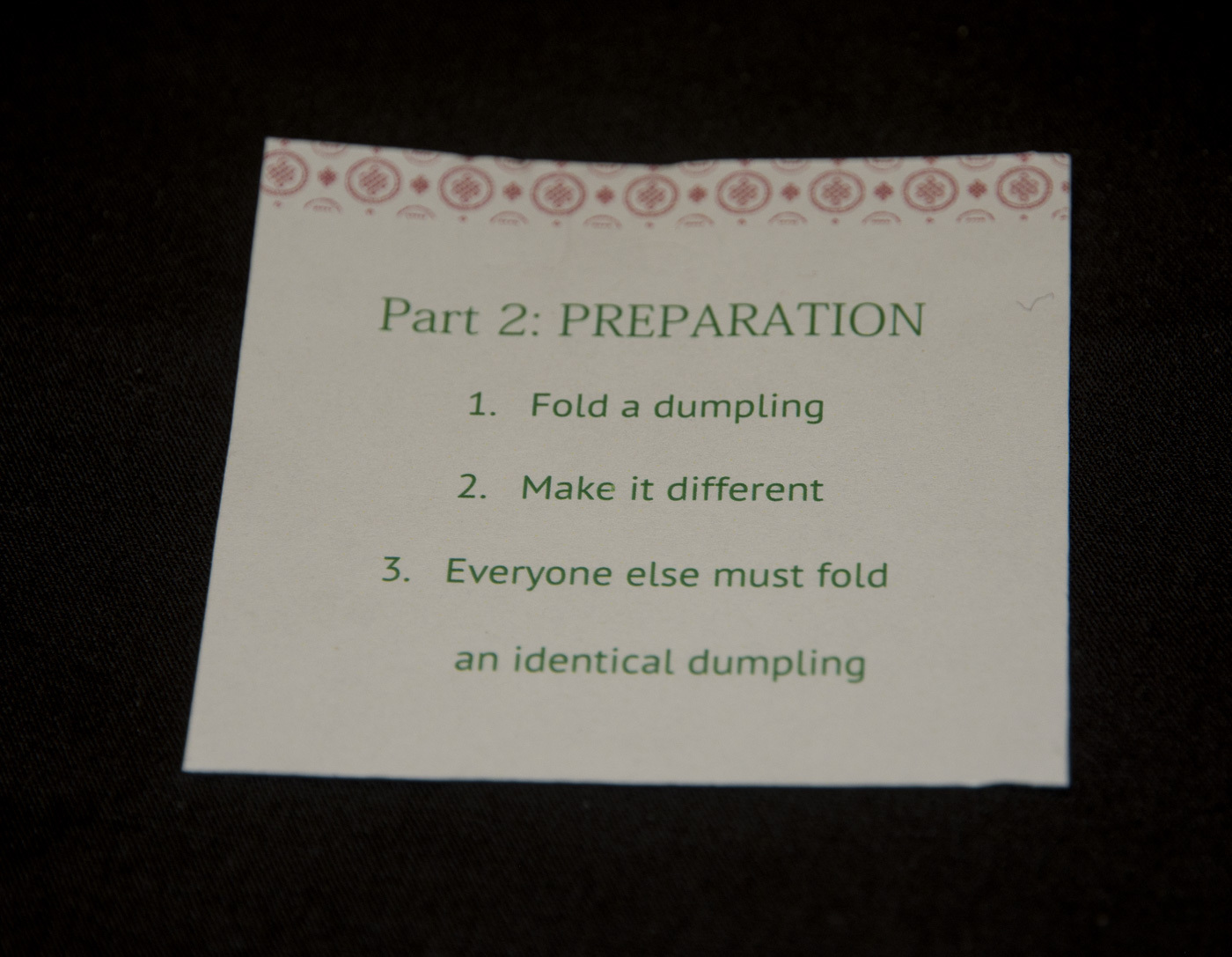 a sheet of instructions that start with "1. fold a dumpling 2. Make it different . . ."