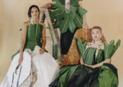 Three individuals wearing large green tetrapanax papyrifer leaf-inspired dresses