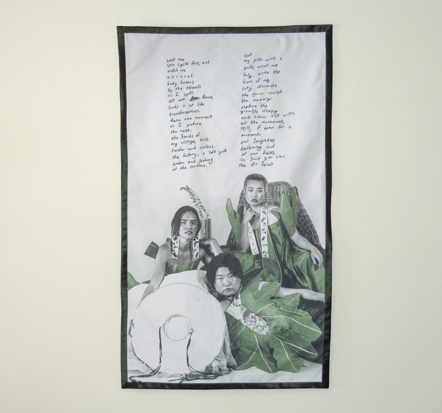 fabric embroidered with a poem and printed with the images of three people wearing green dresses
