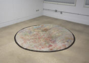 a colorful rainbow circle sits in the middle of a room.